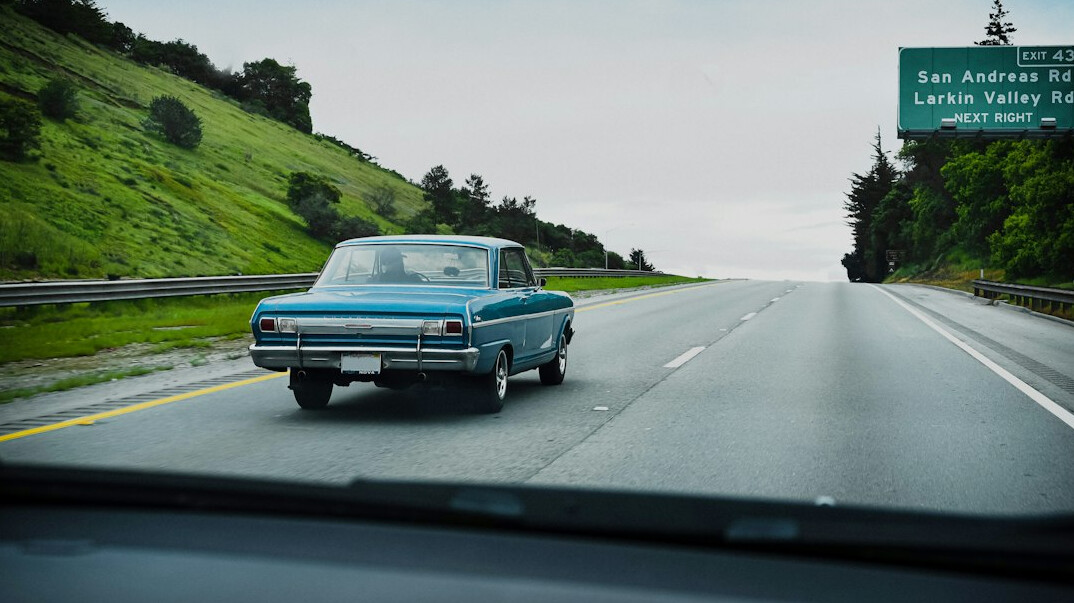 Classic car parked on an empty road