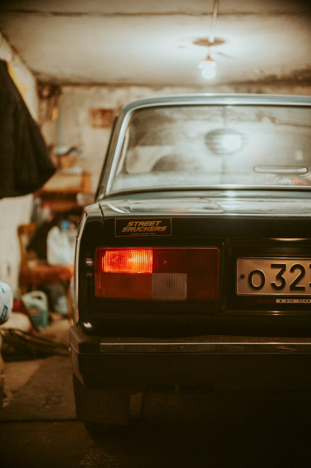 Mechanic checking a car engine in a garage